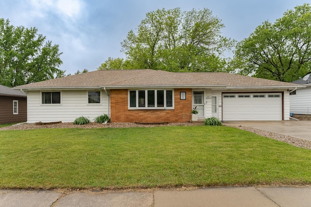 1000 17th St SW, Austin, MN 55912 - single story home with concrete driveway, an attached garage, a front yard, and brick siding