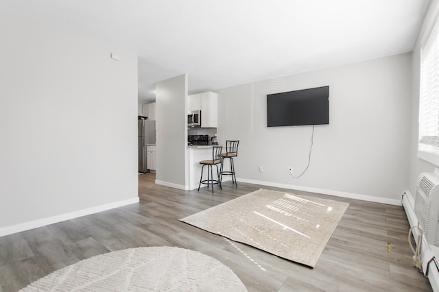 2616 Harriet Ave Unit 117, Minneapolis, MN 55408 - living area featuring light wood-type flooring and baseboards