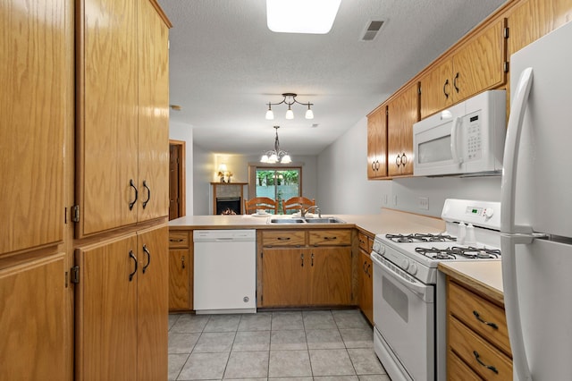1022 17th Ave SE, Forest Lake, MN 55025 - kitchen featuring white appliances, a sink, light countertops, light tile patterned floors, and a textured ceiling