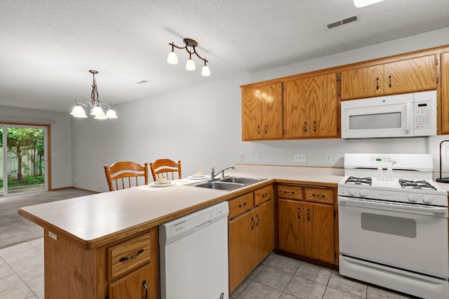 1022 17th Ave SE, Forest Lake, MN 55025 - kitchen with white appliances, a sink, a peninsula, light countertops, and light tile patterned floors