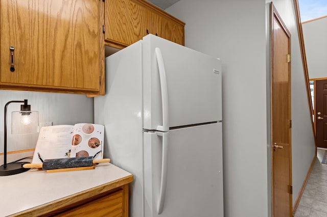 1022 17th Ave SE, Forest Lake, MN 55025 - kitchen with freestanding refrigerator, light countertops, and brown cabinets