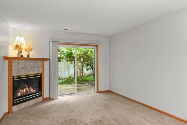 1022 17th Ave SE, Forest Lake, MN 55025 - unfurnished living room featuring a tile fireplace, carpet flooring, and baseboards