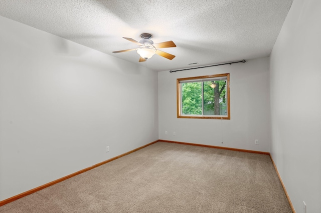 1022 17th Ave SE, Forest Lake, MN 55025 - empty room featuring light carpet, a textured ceiling, a ceiling fan, and baseboards