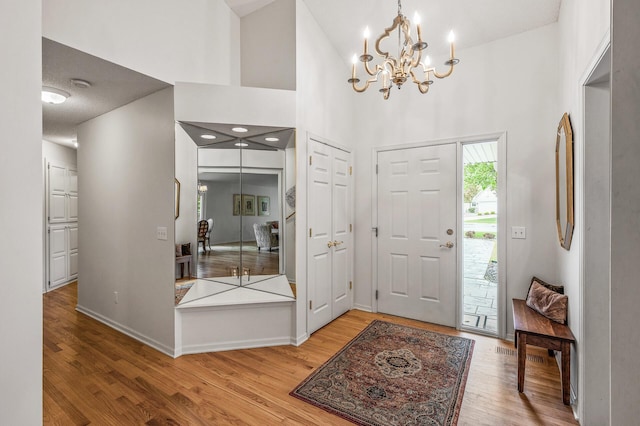 2600 Parkview Ct, White Bear Twp, MN 55110 - entryway featuring wood finished floors, a chandelier, a towering ceiling, and baseboards