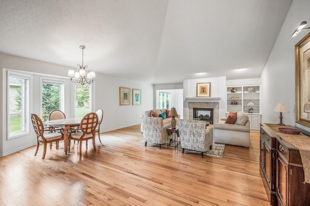2600 Parkview Ct, White Bear Twp, MN 55110 - living area with a chandelier, light wood-style flooring, a fireplace, and built in shelves
