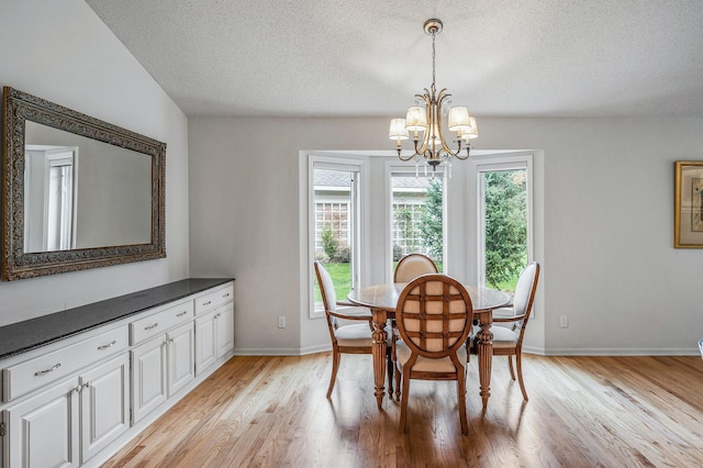 2600 Parkview Ct, White Bear Twp, MN 55110 - dining area featuring a textured ceiling, a chandelier, light wood-style floors, and baseboards