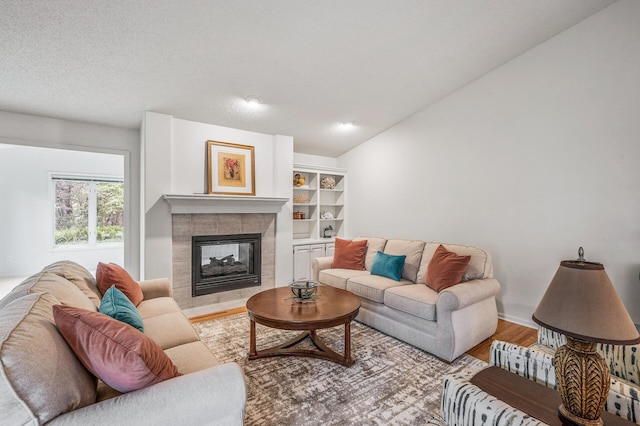 2600 Parkview Ct, White Bear Twp, MN 55110 - living room with wood finished floors, a fireplace, lofted ceiling, and baseboards