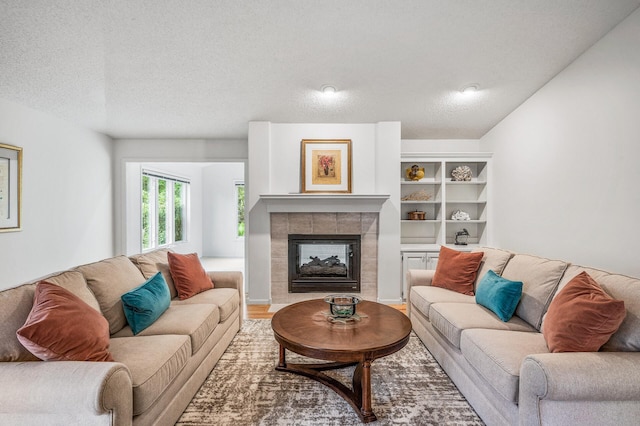 2600 Parkview Ct, White Bear Twp, MN 55110 - living room featuring a fireplace, a textured ceiling, and wood finished floors