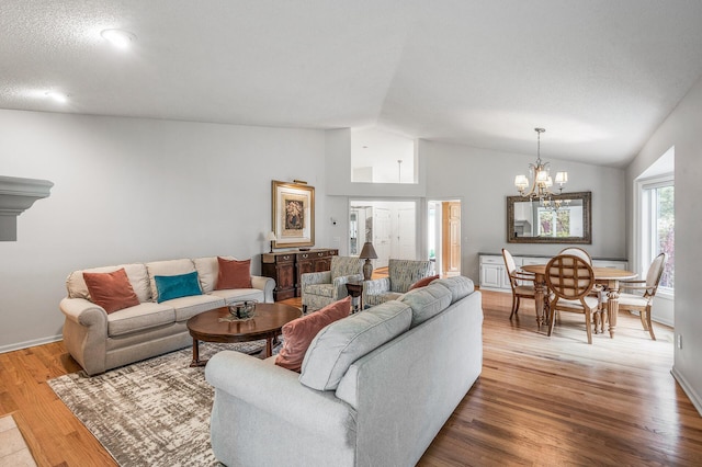 2600 Parkview Ct, White Bear Twp, MN 55110 - living area with a chandelier, vaulted ceiling, wood finished floors, and baseboards