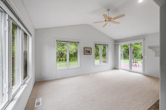 2600 Parkview Ct, White Bear Twp, MN 55110 - carpeted spare room featuring healthy amount of natural light, lofted ceiling, ceiling fan, baseboards, and a textured ceiling