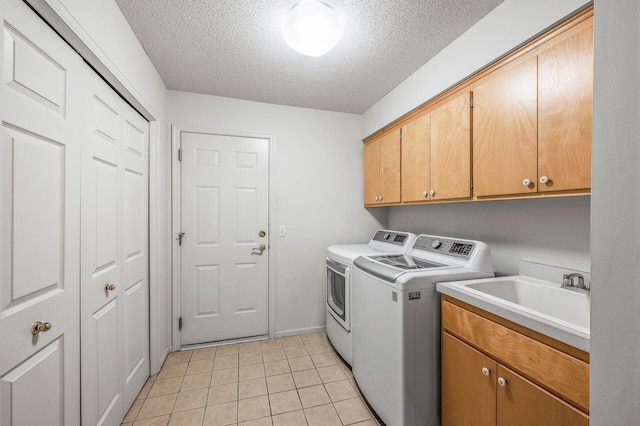2600 Parkview Ct, White Bear Twp, MN 55110 - washroom with cabinet space, a textured ceiling, independent washer and dryer, light tile patterned floors, and baseboards
