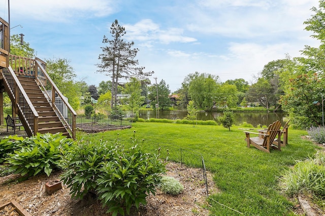 6504 Warren Ave S, Edina, MN 55439 - view of green lawn featuring stairway, a water view, and a vegetable garden