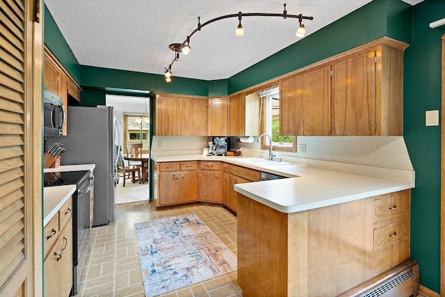 6504 Warren Ave S, Edina, MN 55439 - kitchen with black range with electric cooktop, stainless steel microwave, a sink, and light countertops