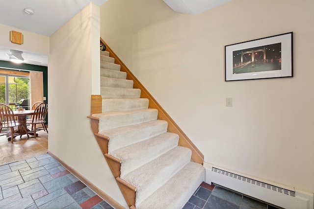 6504 Warren Ave S, Edina, MN 55439 - stairway with baseboard heating, stone tile floors, and baseboards