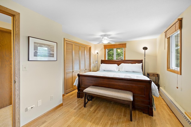 6504 Warren Ave S, Edina, MN 55439 - bedroom featuring a baseboard heating unit, light wood-style flooring, baseboards, and a ceiling fan