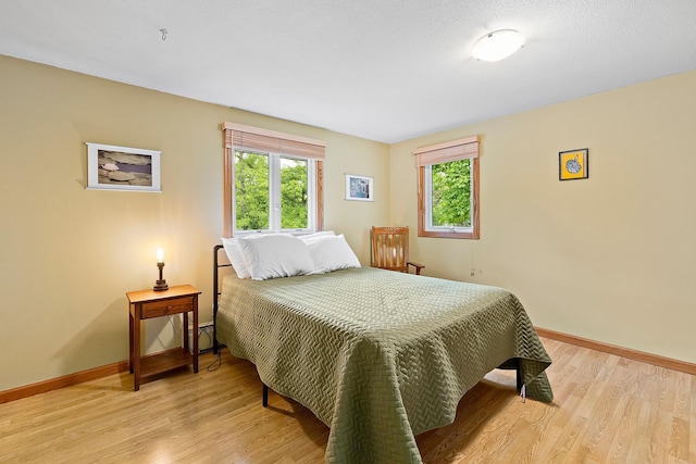 6504 Warren Ave S, Edina, MN 55439 - bedroom featuring baseboards and light wood finished floors