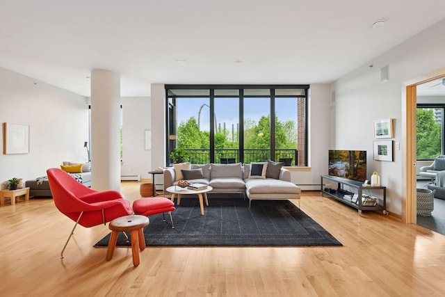 215 10th Ave S Unit 312, Minneapolis, MN 55415 - living area with wood finished floors and a baseboard heating unit