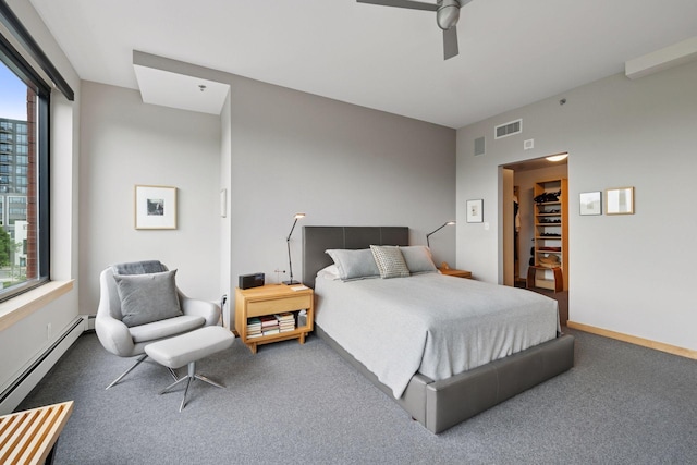 215 10th Ave S Unit 312, Minneapolis, MN 55415 - bedroom with a baseboard radiator, carpet flooring, a ceiling fan, and a spacious closet