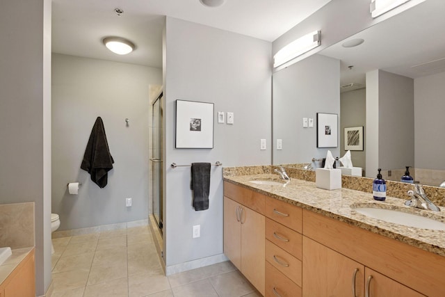 215 10th Ave S Unit 312, Minneapolis, MN 55415 - full bath with double vanity, a shower stall, toilet, and tile patterned flooring