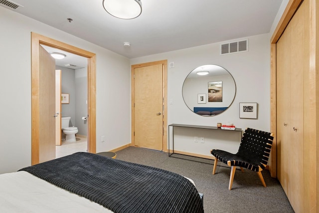 215 10th Ave S Unit 312, Minneapolis, MN 55415 - carpeted bedroom with connected bathroom and baseboards