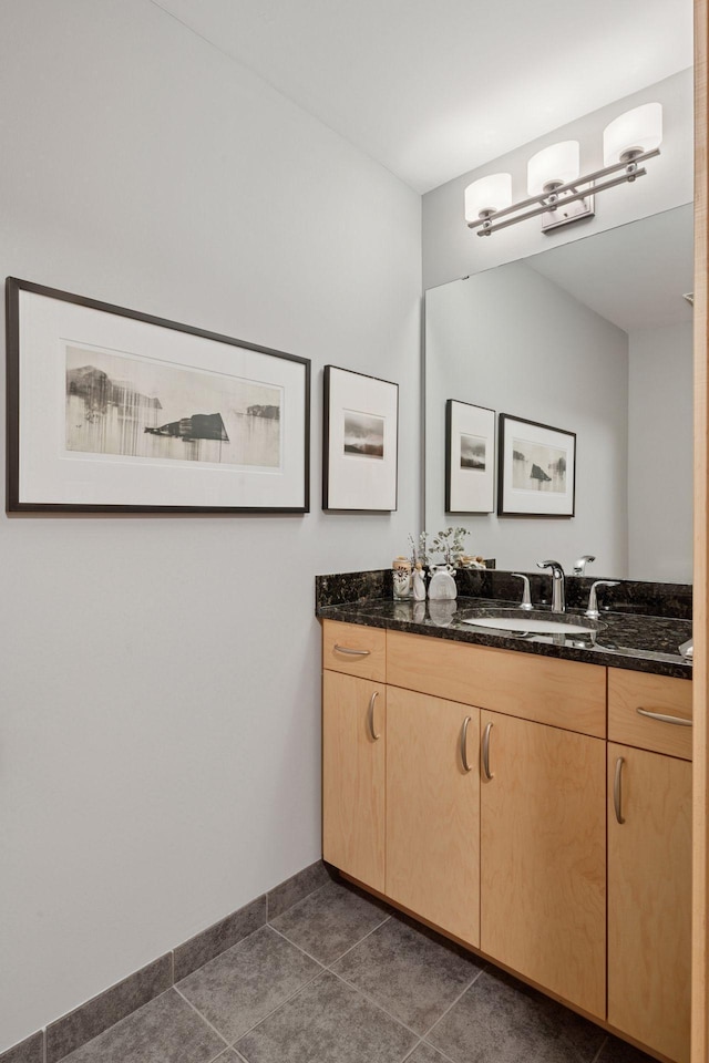 215 10th Ave S Unit 312, Minneapolis, MN 55415 - bathroom with vanity, tile patterned flooring, and baseboards