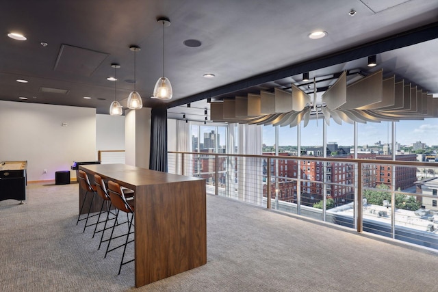 215 10th Ave S Unit 312, Minneapolis, MN 55415 - kitchen with carpet, a ceiling fan, a city view, and hanging light fixtures