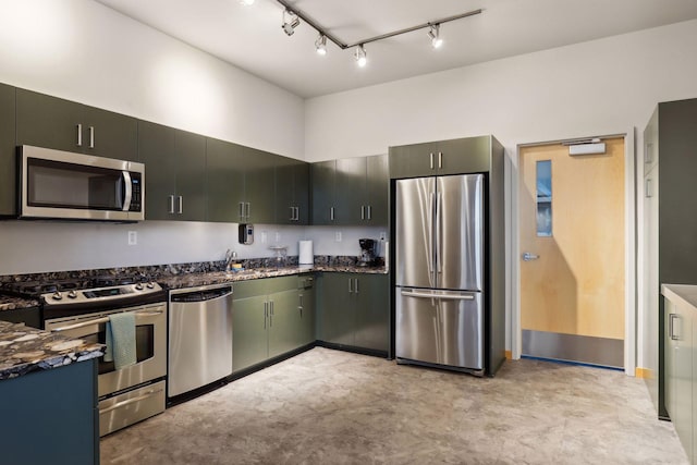 215 10th Ave S Unit 312, Minneapolis, MN 55415 - kitchen with appliances with stainless steel finishes, dark stone countertops, a sink, and track lighting