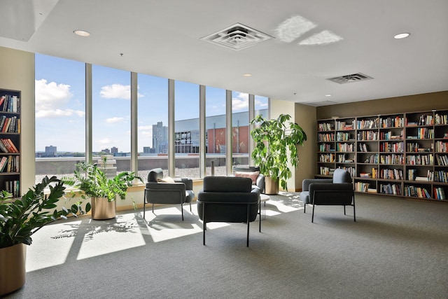 215 10th Ave S Unit 312, Minneapolis, MN 55415 - sitting room featuring bookshelves, carpet floors, healthy amount of natural light, a city view, and recessed lighting