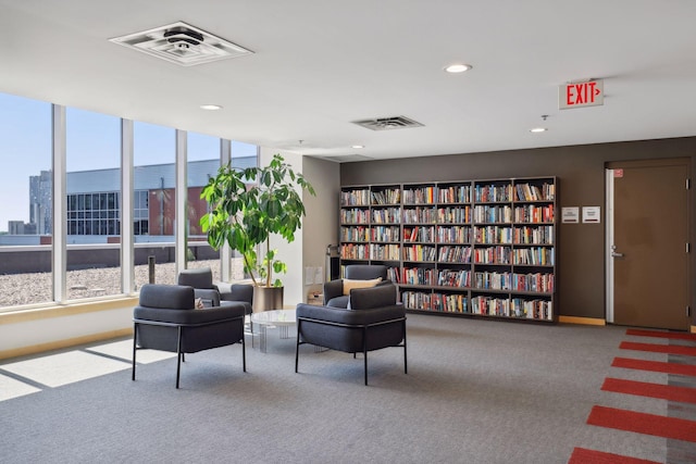 215 10th Ave S Unit 312, Minneapolis, MN 55415 - living area with carpet floors, recessed lighting, and bookshelves