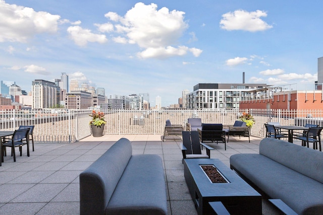 215 10th Ave S Unit 312, Minneapolis, MN 55415 - view of patio featuring an outdoor living space with a fire pit, outdoor dining space, and a view of city