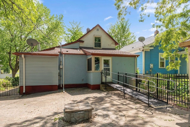 39 Magnolia Ave E, Saint Paul, MN 55117 - back of house with stucco siding, a fire pit, a patio, and a shingled roof