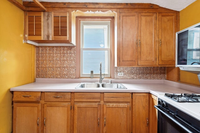 39 Magnolia Ave E, Saint Paul, MN 55117 - kitchen featuring a sink, gas range oven, decorative backsplash, and light countertops
