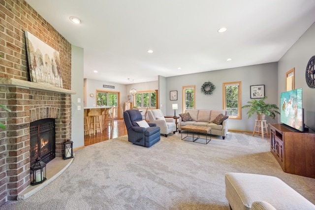 14450 Blackberry Ct, Baxter, MN 56425 - carpeted living room with plenty of natural light, a brick fireplace, recessed lighting, and baseboards