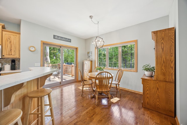 14450 Blackberry Ct, Baxter, MN 56425 - dining area featuring wood-type flooring, a chandelier, and baseboards