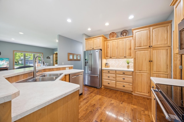 14450 Blackberry Ct, Baxter, MN 56425 - kitchen with stainless steel appliances, a sink, light countertops, hardwood / wood-style floors, and recessed lighting