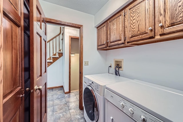 1321 Dallager Ct, Stillwater, MN 55082 - laundry room featuring independent washer and dryer, cabinet space, baseboards, and a textured ceiling