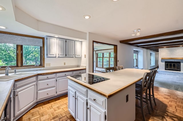 1321 Dallager Ct, Stillwater, MN 55082 - kitchen with black electric cooktop, a sink, a breakfast bar area, recessed lighting, and light countertops