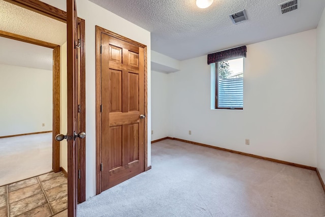 1321 Dallager Ct, Stillwater, MN 55082 - unfurnished bedroom with light colored carpet, a textured ceiling, and baseboards