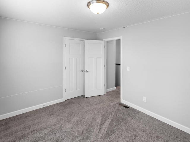 7121 208th St N, Forest Lake, MN 55025 - unfurnished bedroom featuring carpet flooring, a closet, and a textured ceiling