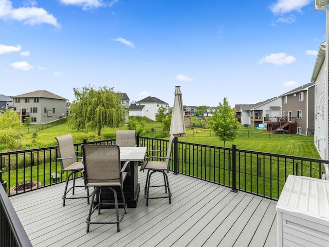 7121 208th St N, Forest Lake, MN 55025 - wooden terrace featuring outdoor dining area, a residential view, and a lawn