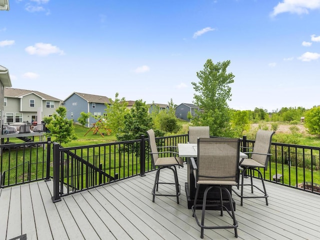 7121 208th St N, Forest Lake, MN 55025 - wooden deck with a residential view, outdoor dining space, and a lawn
