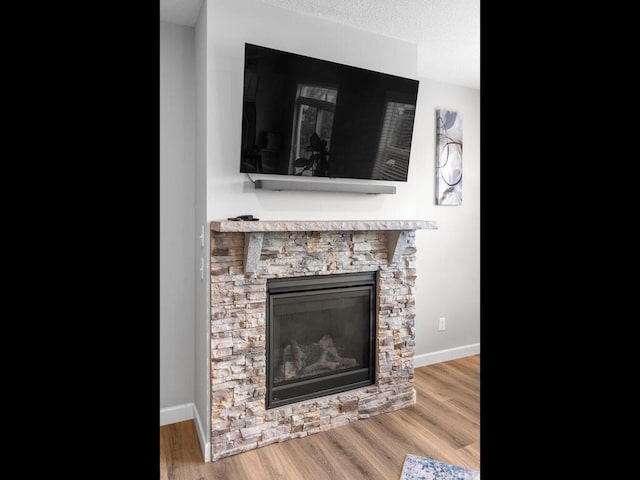 7121 208th St N, Forest Lake, MN 55025 - detailed view of a fireplace, wood finished floors, and a textured ceiling