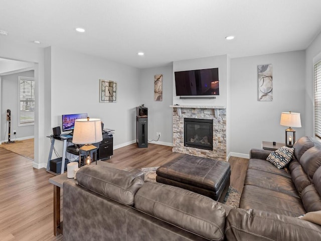 7121 208th St N, Forest Lake, MN 55025 - living area featuring wood finished floors, recessed lighting, and a stone fireplace