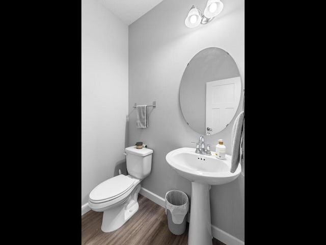7121 208th St N, Forest Lake, MN 55025 - half bathroom featuring toilet and wood finished floors