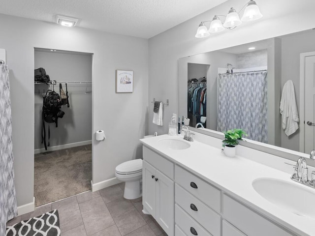 7121 208th St N, Forest Lake, MN 55025 - bathroom featuring a spacious closet, double vanity, a textured ceiling, curtained shower, and tile patterned flooring