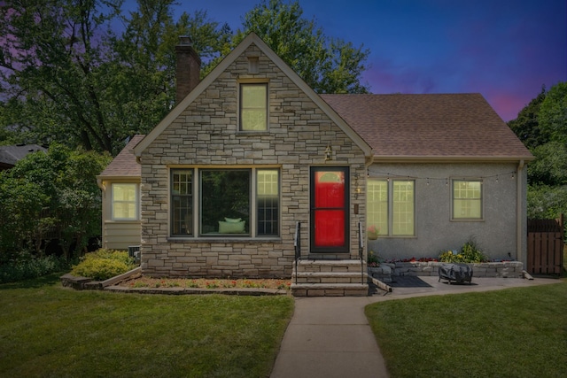 5640 13th Ave S, Minneapolis, MN 55417 - view of front facade featuring stone siding, a chimney, a shingled roof, and entry steps