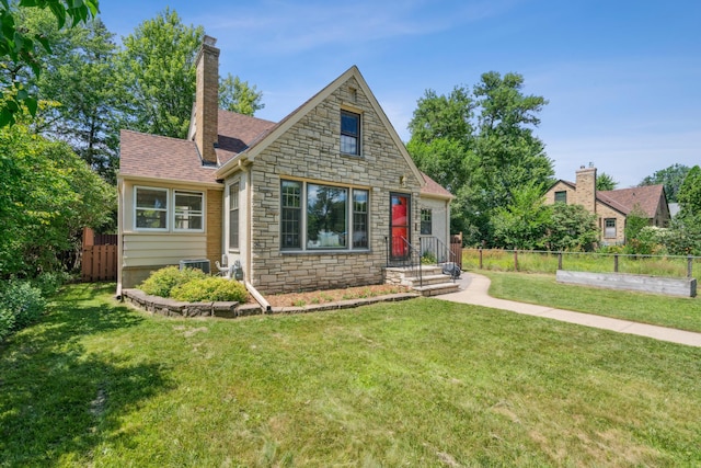 5640 13th Ave S, Minneapolis, MN 55417 - view of front of property with stone siding, a chimney, and roof with shingles