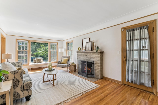 5640 13th Ave S, Minneapolis, MN 55417 - living area with light wood-style floors, a brick fireplace, and ornamental molding