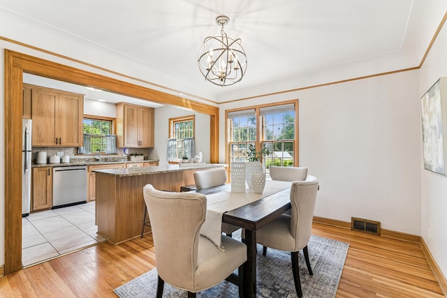 5640 13th Ave S, Minneapolis, MN 55417 - dining space featuring a chandelier and light wood finished floors