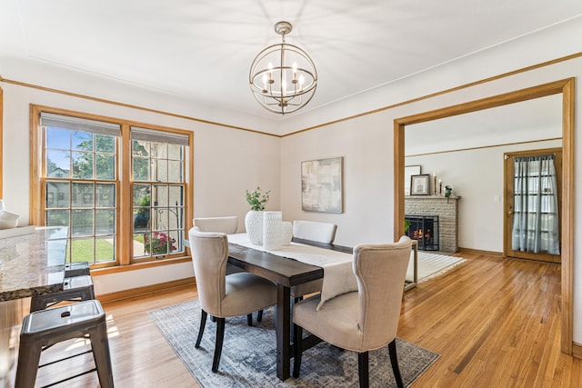 5640 13th Ave S, Minneapolis, MN 55417 - dining area featuring a chandelier, a brick fireplace, and light wood-style floors